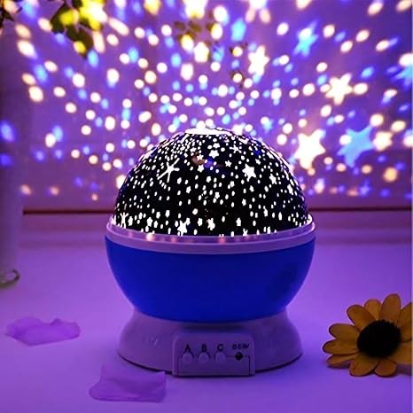 Star projector lamp projecting stars on ceiling